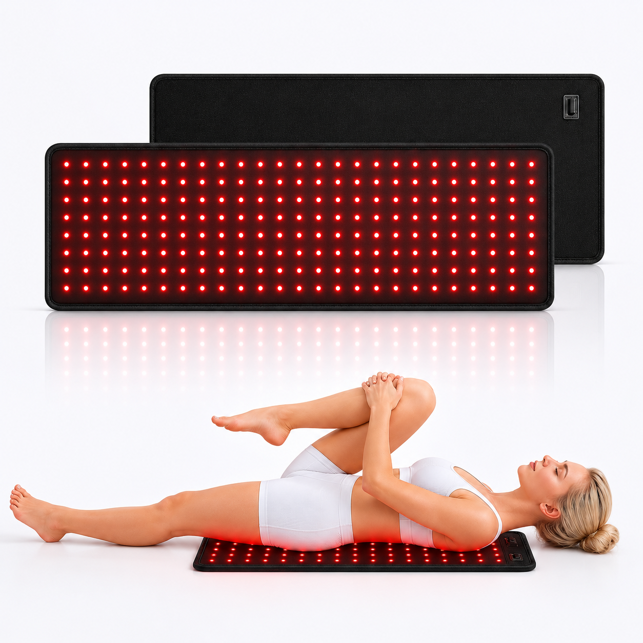 Woman lying on a red light therapy mat with another mat above her on a white background
