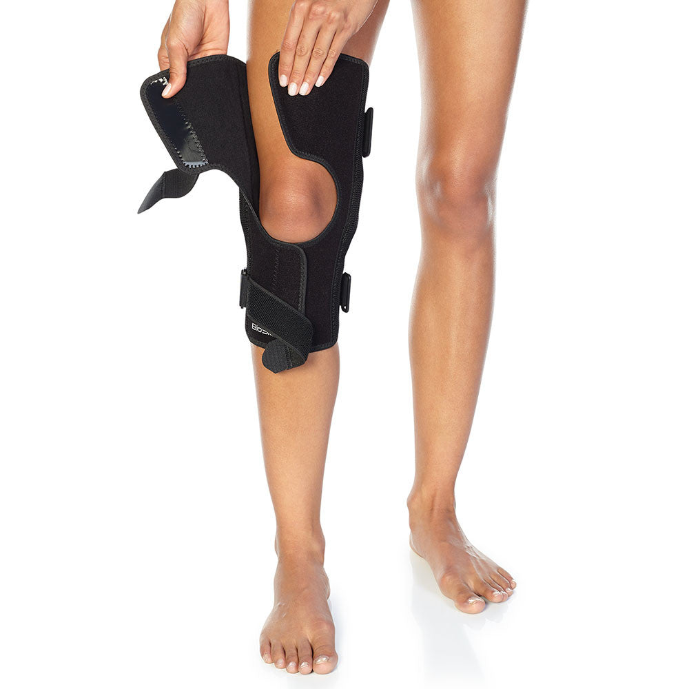 Patellofemoral Tracking Wraparound Knee Brace with Dynamic Lateral Support and Flexible Hinges.